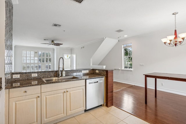 kitchen with stainless steel dishwasher, light hardwood / wood-style floors, sink, and a wealth of natural light