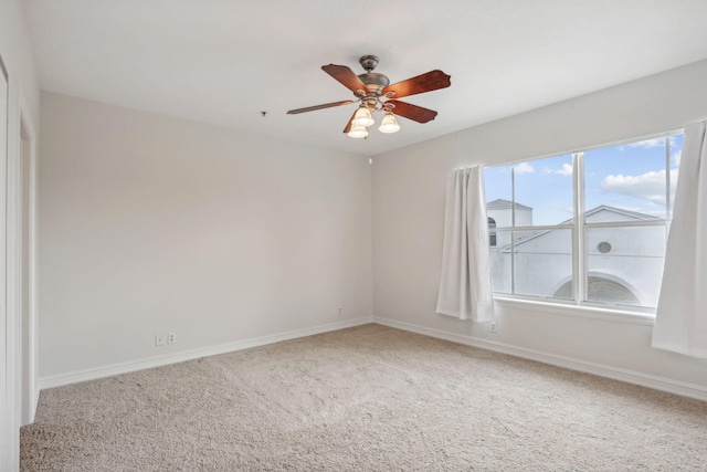 spare room with carpet floors and ceiling fan