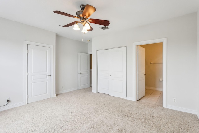 unfurnished bedroom featuring connected bathroom, ceiling fan, and light carpet