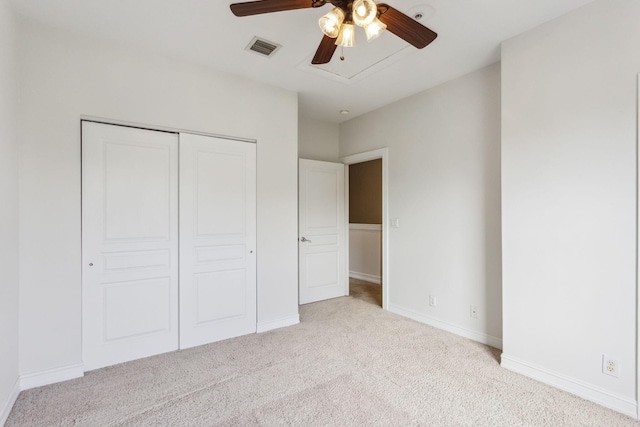 unfurnished bedroom with a closet, ceiling fan, and light colored carpet