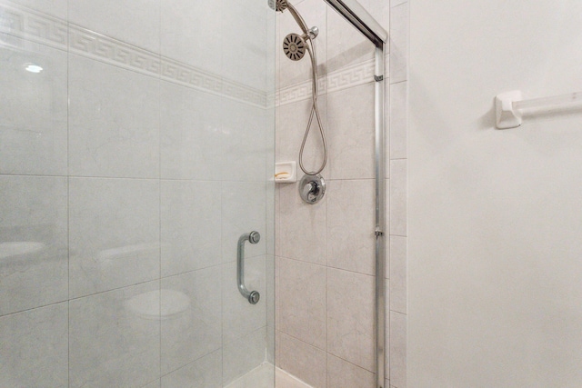 bathroom featuring a shower with door