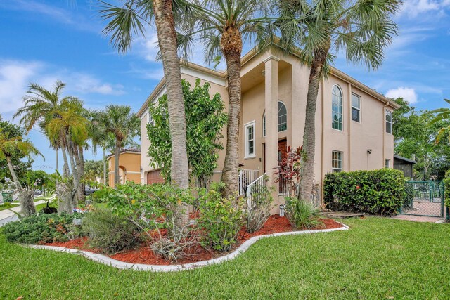 view of front of property featuring a garage and a front lawn