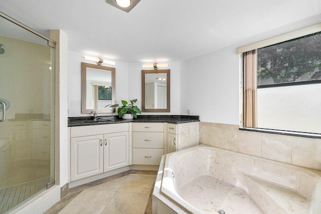 bathroom with shower with separate bathtub, vanity, and tile patterned floors