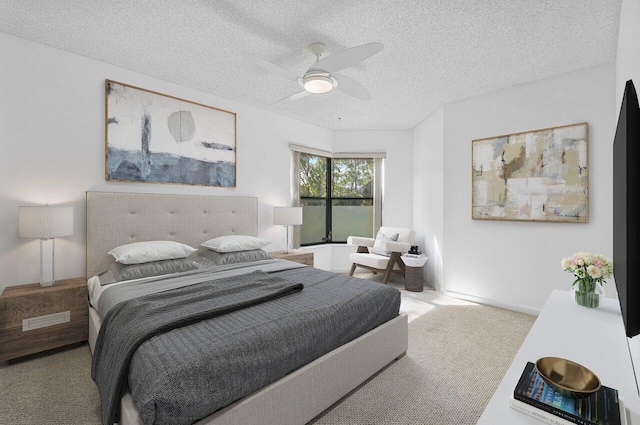 bedroom featuring a textured ceiling, ceiling fan, and carpet flooring