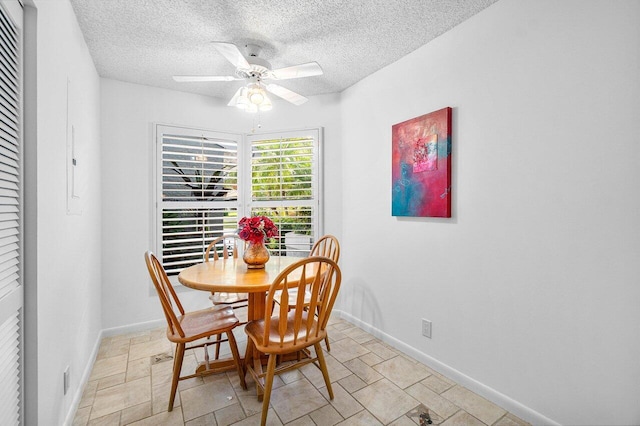 dining room with a textured ceiling and ceiling fan