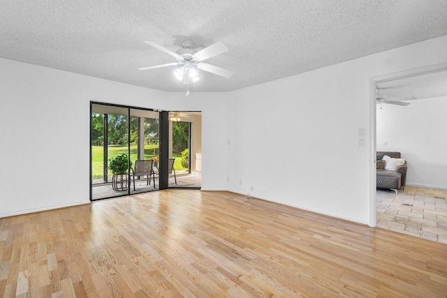 unfurnished room with a textured ceiling, ceiling fan, and light wood-type flooring