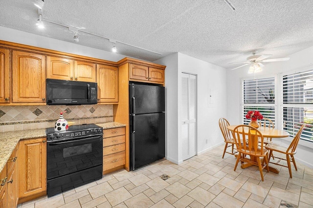 kitchen with black appliances, ceiling fan, light stone countertops, and tasteful backsplash