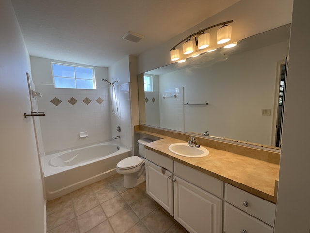 full bathroom with toilet, tiled shower / bath combo, tile patterned flooring, and vanity