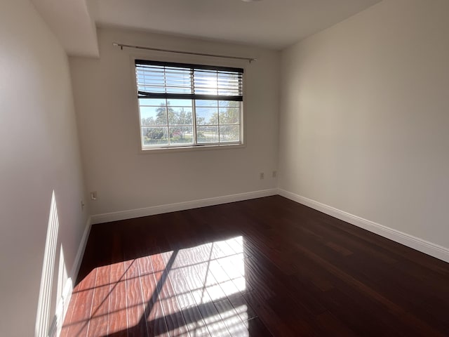 unfurnished room with hardwood / wood-style flooring