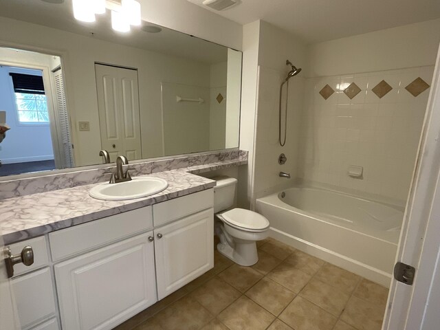 full bathroom with toilet, tile patterned flooring, vanity, and  shower combination