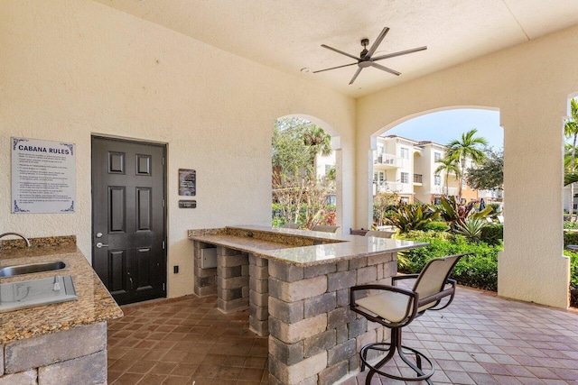 view of patio featuring ceiling fan and an outdoor wet bar