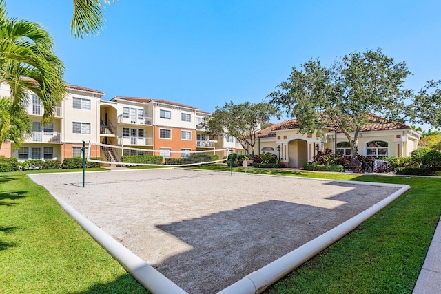 surrounding community featuring volleyball court and a lawn