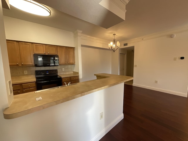 kitchen featuring black appliances, a notable chandelier, pendant lighting, dark hardwood / wood-style flooring, and decorative backsplash