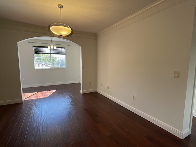 spare room featuring ornamental molding and dark hardwood / wood-style flooring