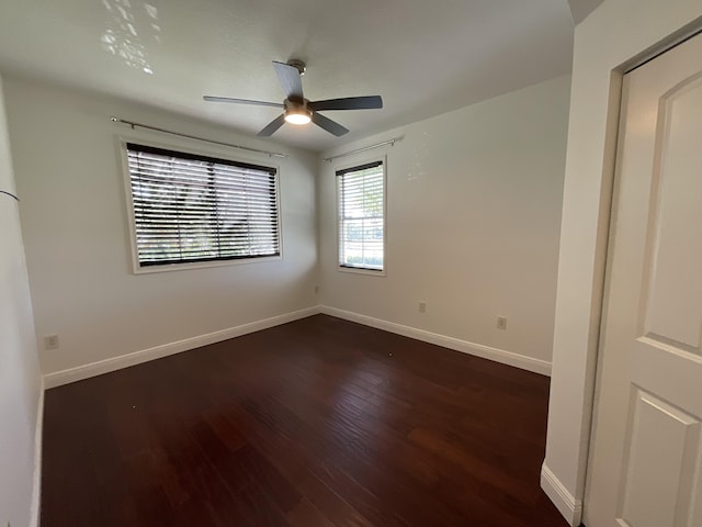 unfurnished room featuring ceiling fan and dark hardwood / wood-style flooring