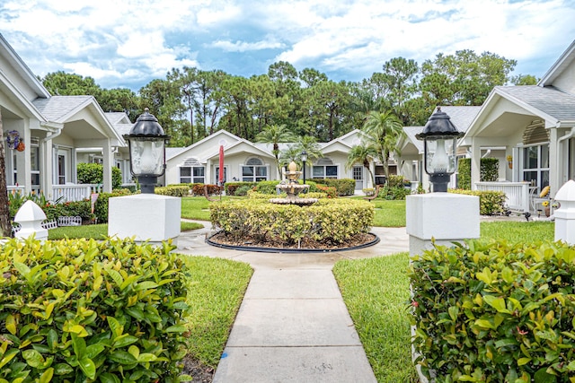 view of property's community with a lawn