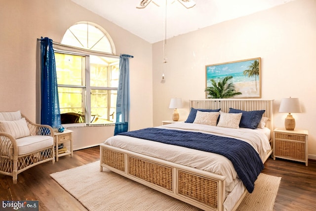 bedroom featuring dark hardwood / wood-style flooring and vaulted ceiling