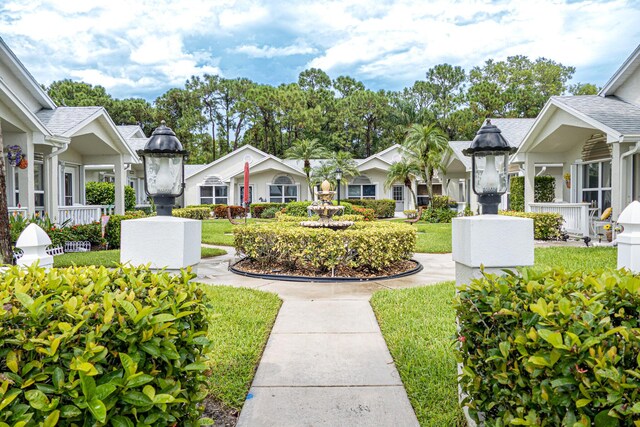 view of property's community featuring a yard