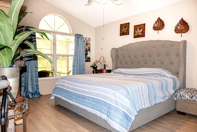 bedroom with hardwood / wood-style flooring and vaulted ceiling