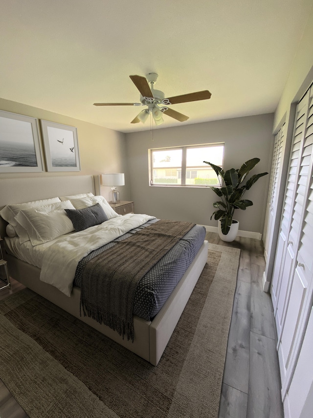 bedroom with ceiling fan and wood-type flooring