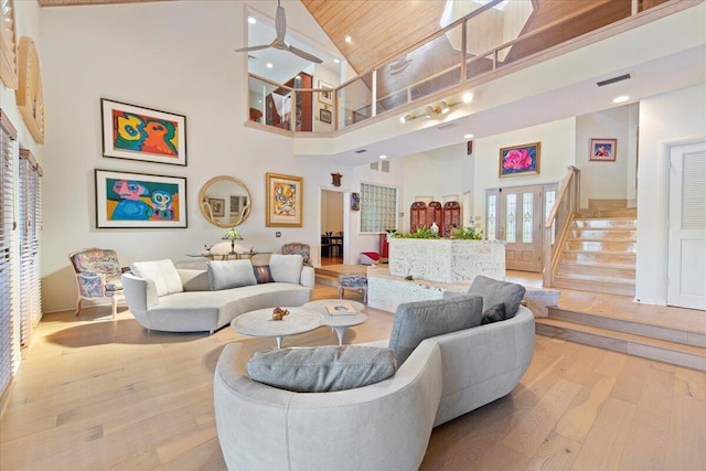 living room featuring wood ceiling, high vaulted ceiling, and light hardwood / wood-style floors