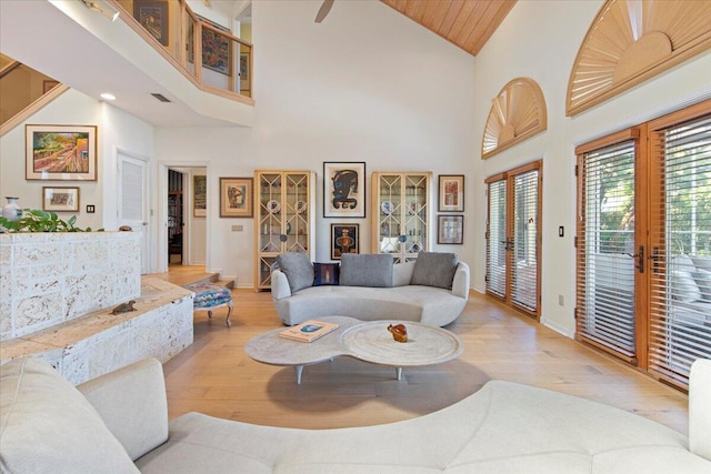 living room with wood ceiling, high vaulted ceiling, french doors, and light wood-type flooring