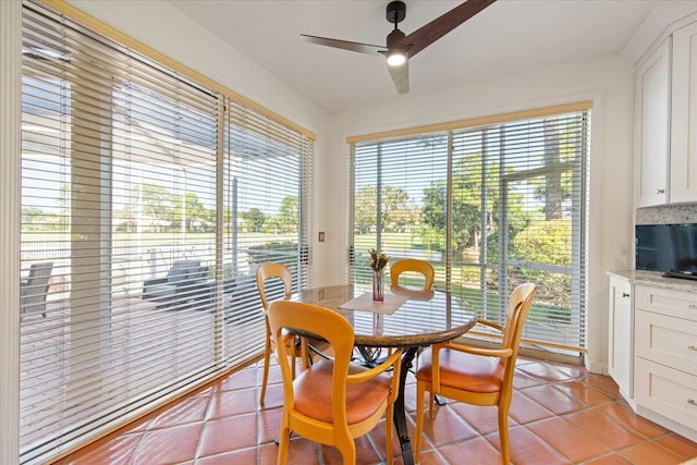 tiled dining room with ceiling fan