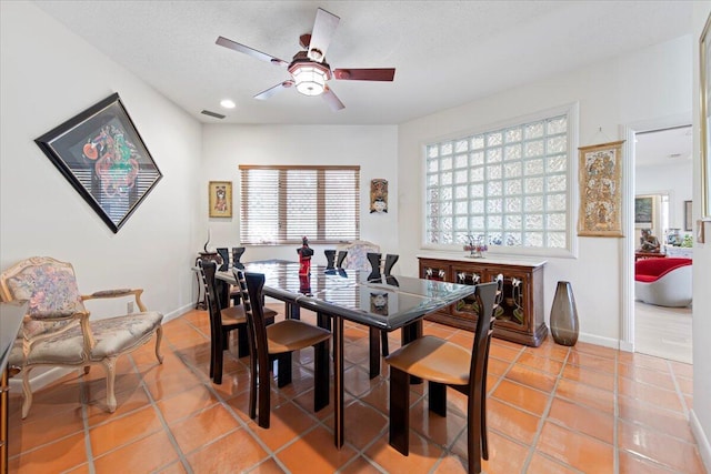 dining space with tile patterned flooring and ceiling fan