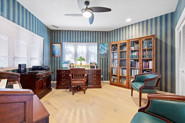 office area with ceiling fan, a textured ceiling, and light hardwood / wood-style floors