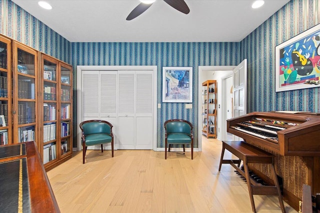 living area featuring ceiling fan and light wood-type flooring