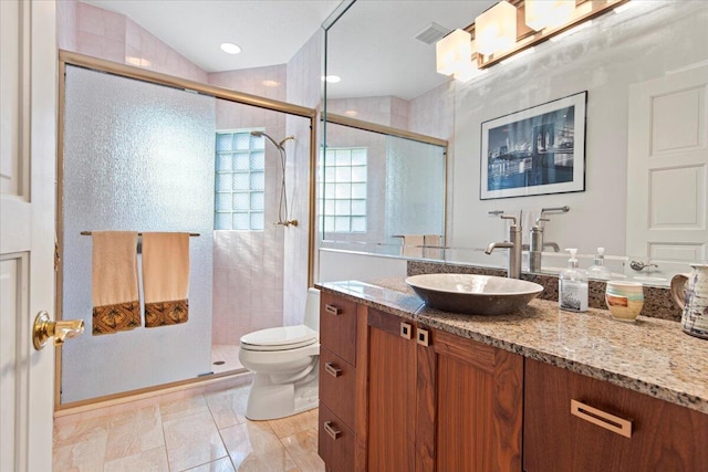 bathroom featuring an enclosed shower, vaulted ceiling, vanity, and toilet