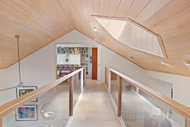 hallway with wood ceiling, lofted ceiling, and hardwood / wood-style flooring