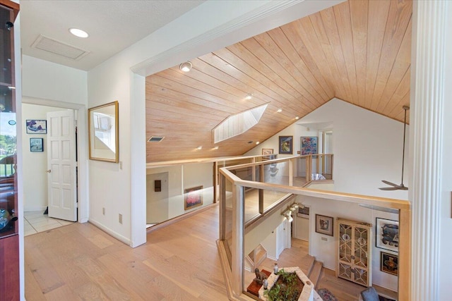 hallway featuring vaulted ceiling, wood ceiling, and light hardwood / wood-style floors