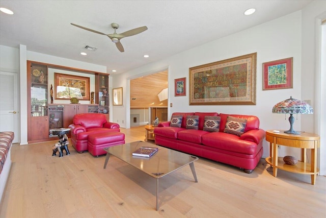 living room featuring light hardwood / wood-style floors and ceiling fan