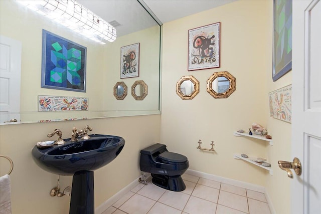 bathroom featuring tile patterned flooring and toilet