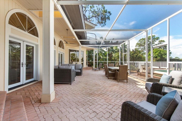 view of patio / terrace with outdoor lounge area, glass enclosure, and french doors