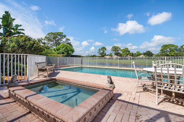 view of swimming pool with an in ground hot tub and a patio