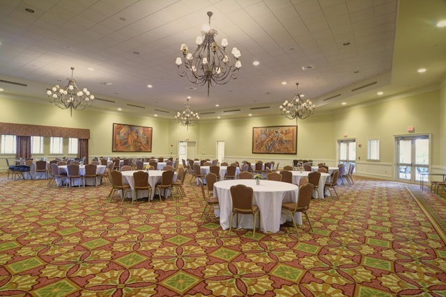 dining room with light colored carpet, ornamental molding, french doors, and a towering ceiling