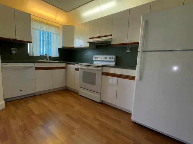 kitchen with light wood-type flooring, white appliances, backsplash, and sink