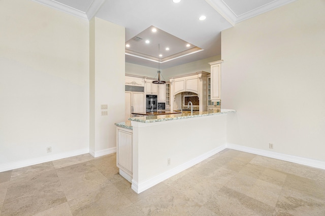 kitchen featuring cream cabinets, paneled built in fridge, tasteful backsplash, light stone counters, and kitchen peninsula