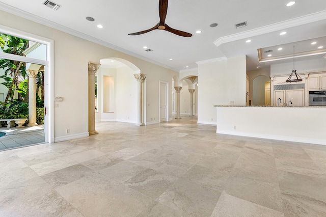 unfurnished living room featuring ceiling fan and ornamental molding