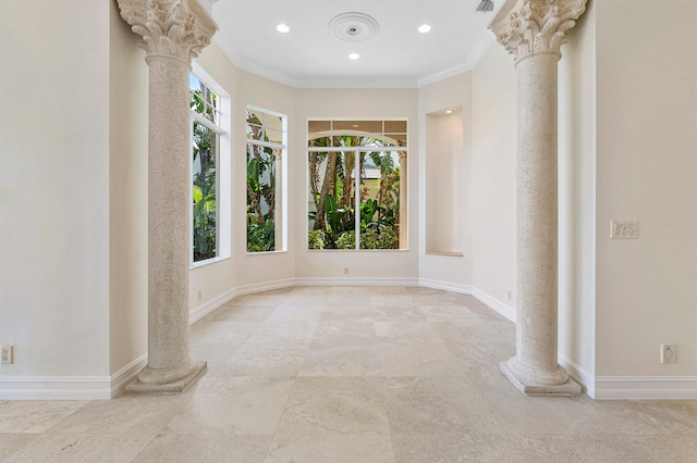 unfurnished room with ornate columns, ornamental molding, and a wealth of natural light