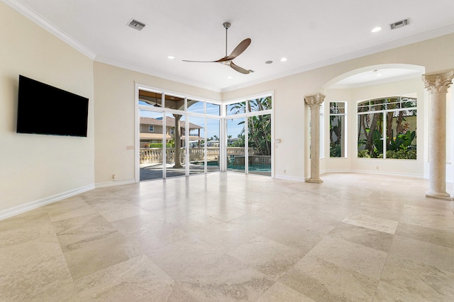 spare room with ceiling fan, crown molding, and decorative columns