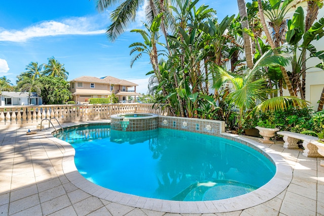 view of pool with an in ground hot tub