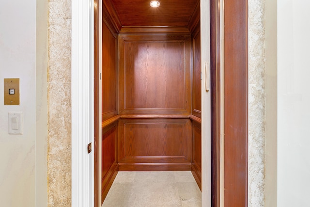 room details with wooden walls and elevator