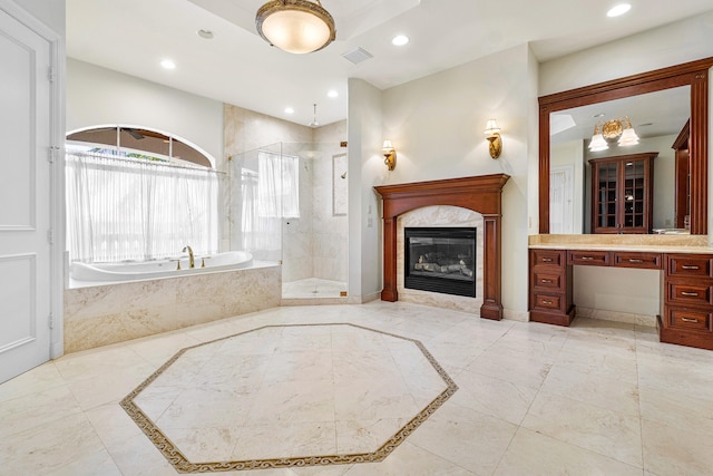 bathroom with vanity and shower with separate bathtub