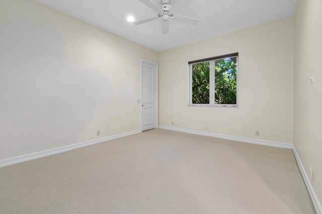 empty room featuring light carpet and ceiling fan