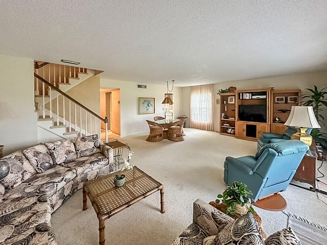 carpeted living room with a textured ceiling