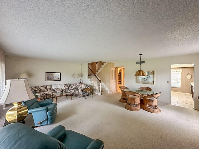 carpeted living room featuring a textured ceiling