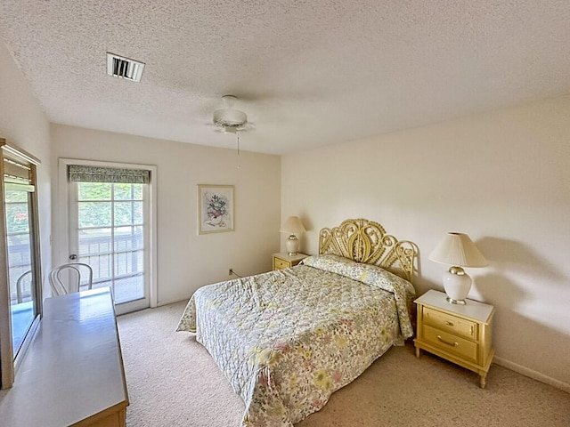 carpeted bedroom featuring a textured ceiling, access to outside, and ceiling fan